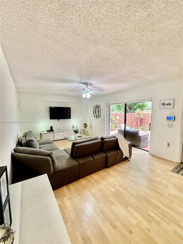 4306 43rd Way, West Palm Beach, FL 33407 - living room featuring light wood-type flooring, a textured ceiling, and a ceiling fan