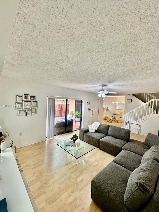 4306 43rd Way, West Palm Beach, FL 33407 - living area with a textured ceiling, wood finished floors, ceiling fan, stairs, and baseboards