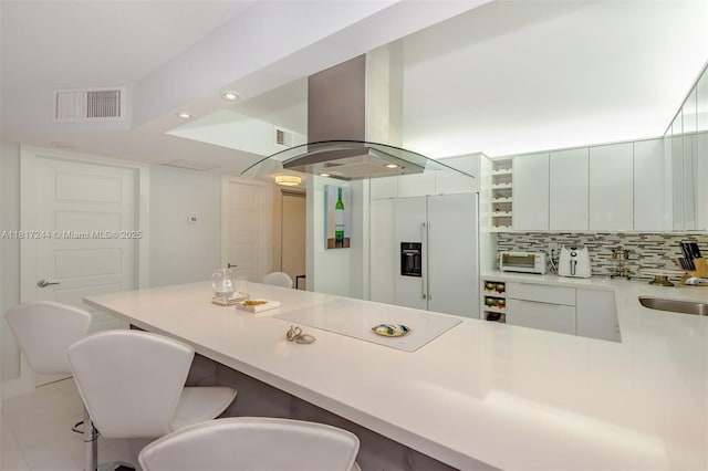 18151 NE 31st Ct Unit 1905, Aventura, FL 33160 - kitchen with high quality fridge, a kitchen breakfast bar, island range hood, a peninsula, and recessed lighting