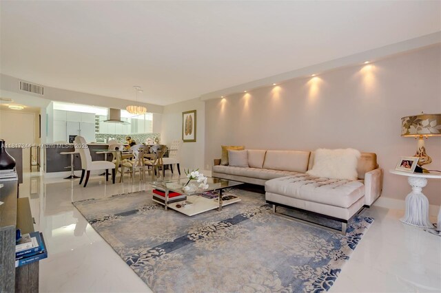 18151 NE 31st Ct Unit 1905, Aventura, FL 33160 - living room with marble tiled flooring and a chandelier
