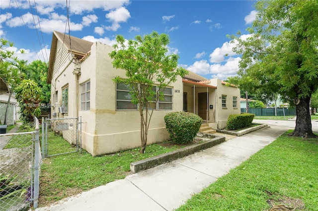 1478 SW 2nd St, Miami, FL 33135 - view of front of house with stucco siding and a gate