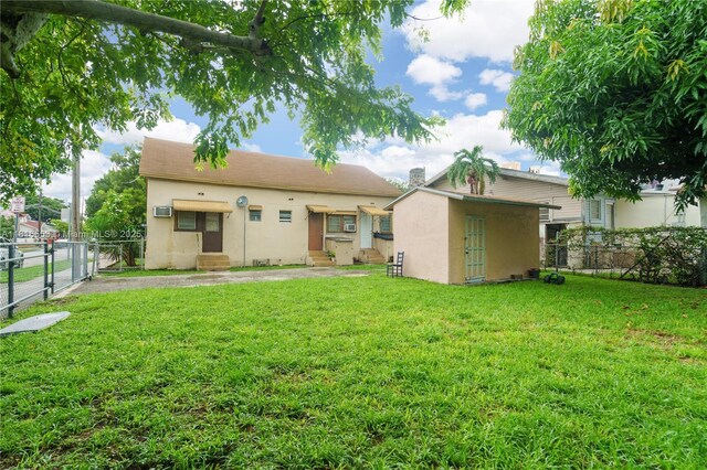 1478 SW 2nd St, Miami, FL 33135 - back of house with entry steps, stucco siding, and an outdoor structure
