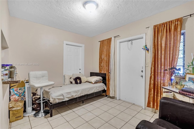 1478 SW 2nd St, Miami, FL 33135 - bedroom featuring a textured ceiling and light tile patterned floors