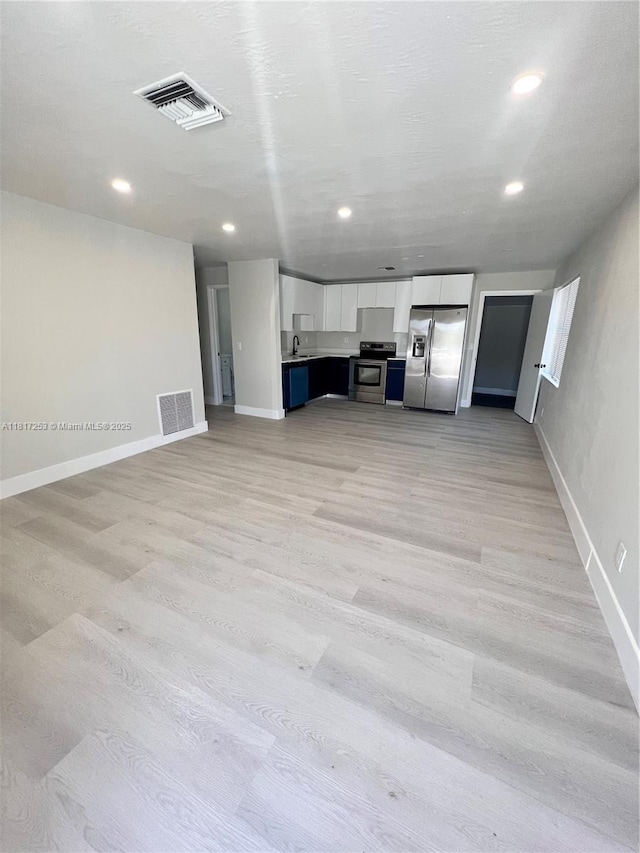 3731 SW 58th Ter, Davie, FL 33314 - unfurnished living room featuring baseboards, light wood-style floors, a sink, and recessed lighting