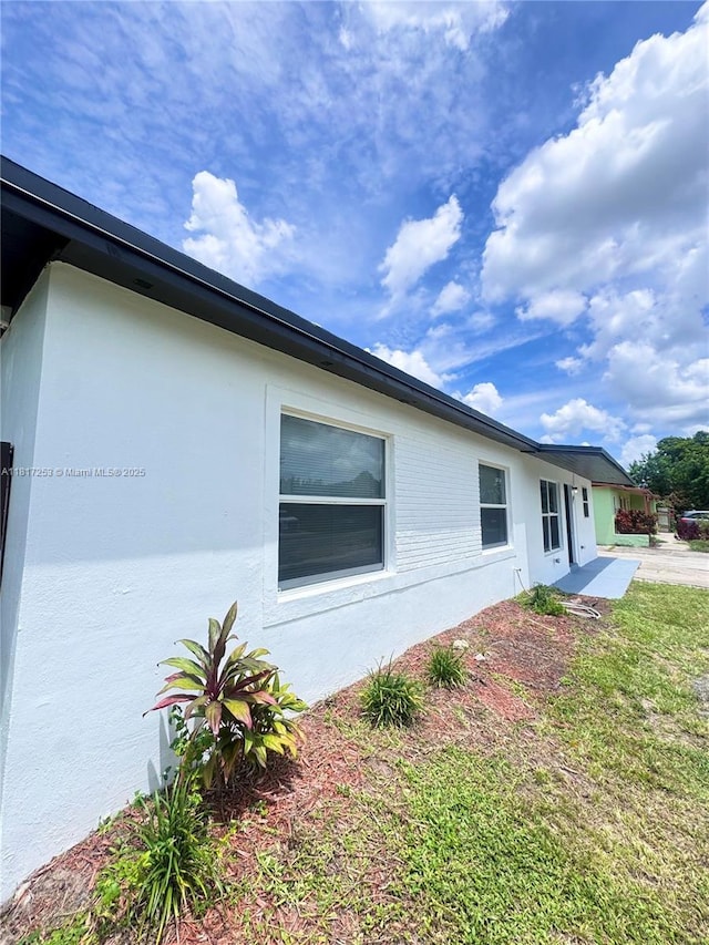 3731 SW 58th Ter, Davie, FL 33314 - view of side of property featuring stucco siding and a yard