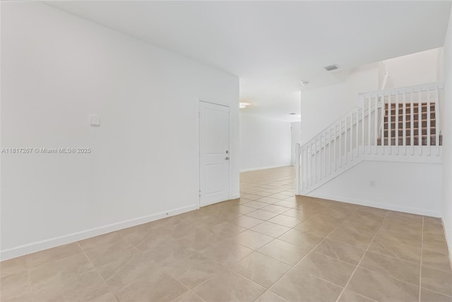 2608 SE 11th Ct Unit 2608, Homestead, FL 33035 - empty room featuring light tile patterned flooring, baseboards, and stairway