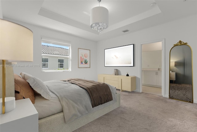 2608 SE 11th Ct Unit 2608, Homestead, FL 33035 - bedroom featuring a raised ceiling, light colored carpet, and connected bathroom