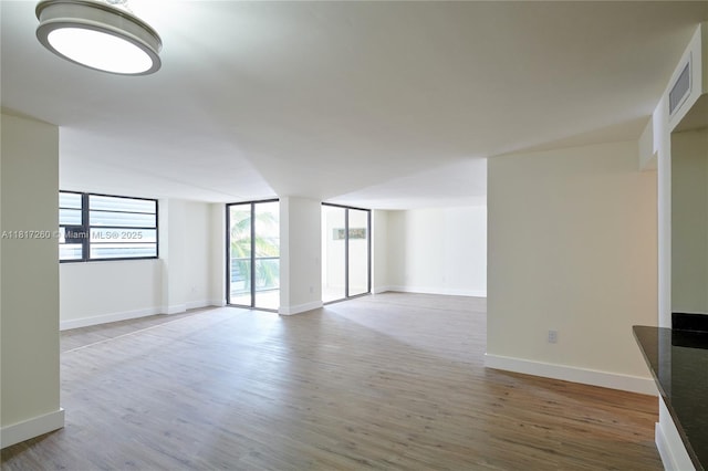 5845 Collins Ave Unit 304, Miami Beach, FL 33140 - spare room featuring light wood-type flooring and baseboards