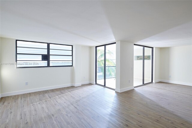 5845 Collins Ave Unit 304, Miami Beach, FL 33140 - spare room with wood finished floors and baseboards