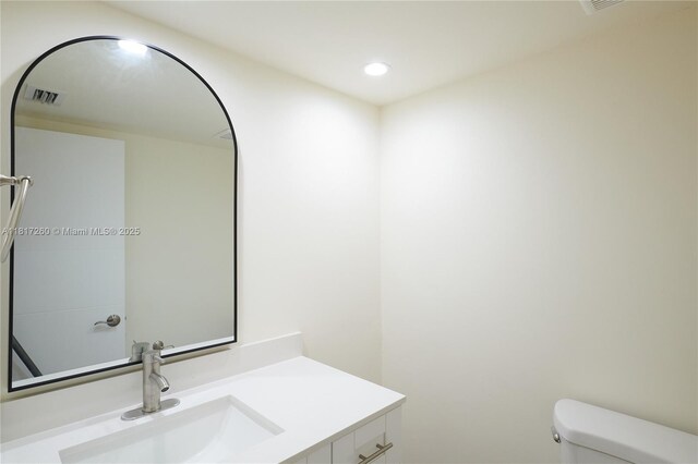 5845 Collins Ave Unit 304, Miami Beach, FL 33140 - bathroom with toilet, vanity, and recessed lighting