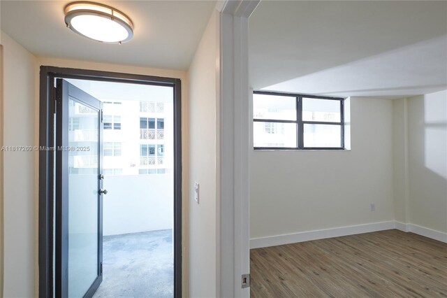5845 Collins Ave Unit 304, Miami Beach, FL 33140 - entryway featuring wood finished floors and baseboards