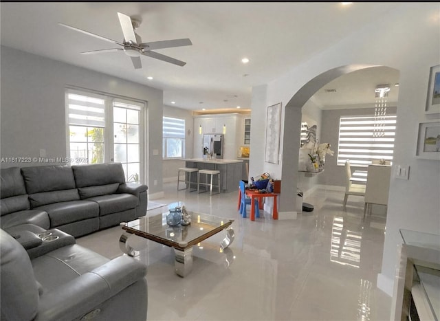 14121 SW 152nd Ter, Miami, FL 33177 - living room with arched walkways, ceiling fan, recessed lighting, and light tile patterned floors