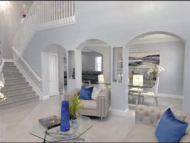 14121 SW 152nd Ter, Miami, FL 33177 - living room with stairs, crown molding, arched walkways, concrete floors, and a high ceiling