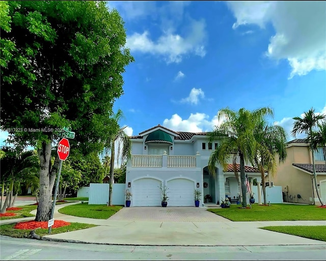 14121 SW 152nd Ter, Miami, FL 33177 - mediterranean / spanish-style home featuring a balcony, an attached garage, driveway, stucco siding, and a tiled roof