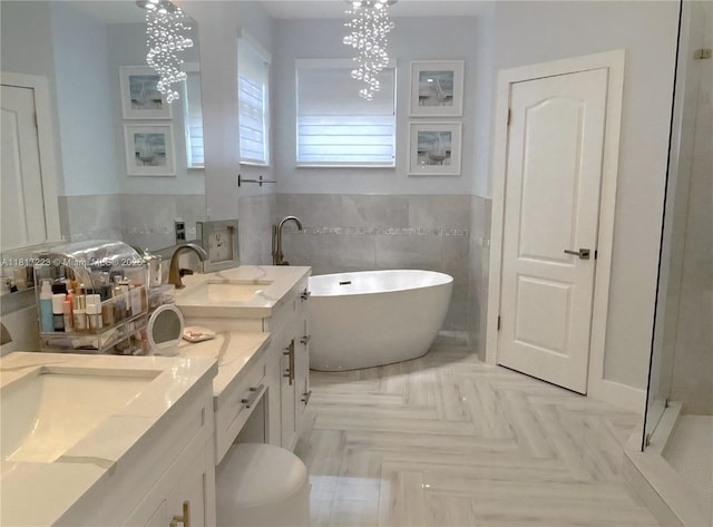 14121 SW 152nd Ter, Miami, FL 33177 - full bathroom with tile walls, a freestanding tub, a chandelier, vanity, and wainscoting