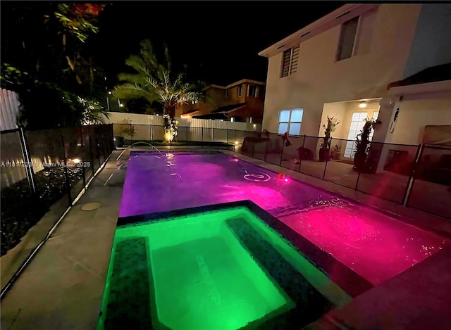 14121 SW 152nd Ter, Miami, FL 33177 - pool at night featuring a pool with connected hot tub
