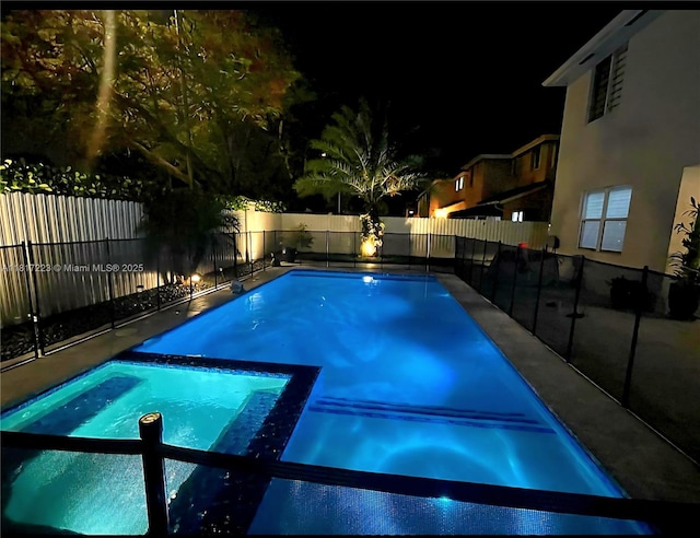 14121 SW 152nd Ter, Miami, FL 33177 - pool at twilight with a pool with connected hot tub and a fenced backyard