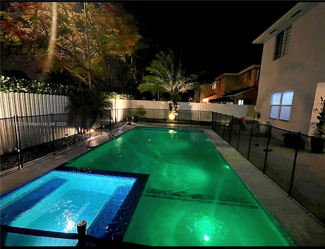14121 SW 152nd Ter, Miami, FL 33177 - pool at night featuring a fenced backyard and a pool with connected hot tub