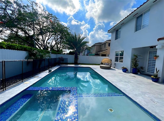 14121 SW 152nd Ter, Miami, FL 33177 - view of pool with a fenced backyard, a pool with connected hot tub, and a patio area