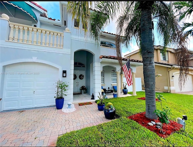 14121 SW 152nd Ter, Miami, FL 33177 - mediterranean / spanish home with a balcony, stucco siding, a tiled roof, a front yard, and decorative driveway