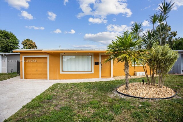 6541 NW 24th St, Sunrise, FL 33313 - single story home featuring stucco siding, concrete driveway, a front lawn, and an attached garage
