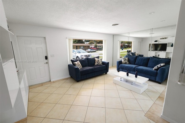 6541 NW 24th St, Sunrise, FL 33313 - living area with a textured ceiling, light tile patterned flooring, and baseboards