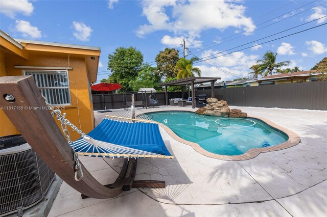 6541 NW 24th St, Sunrise, FL 33313 - view of pool featuring a fenced backyard, central AC unit, and a patio