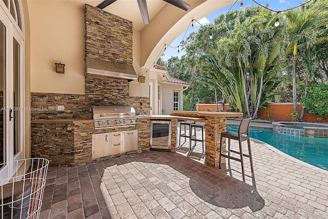 112 Segovia Way, Jupiter, FL 33458 - view of patio / terrace with wine cooler and a pool with connected hot tub