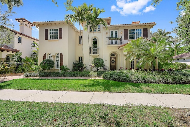 112 Segovia Way, Jupiter, FL 33458 - mediterranean / spanish-style home with a balcony, stucco siding, and a front lawn