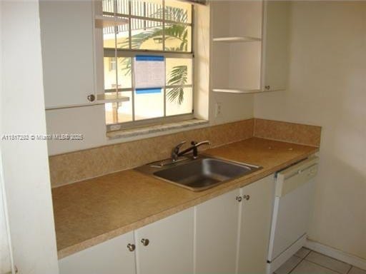 8500 SW 109th Ave Unit 6-118, Miami, FL 33173 - kitchen featuring dishwasher, a sink, open shelves, and white cabinets