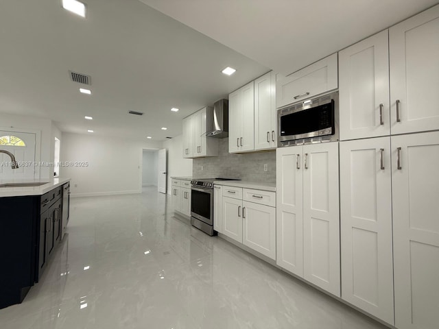 4314 SW 97th Ct, Miami, FL 33165 - kitchen with stainless steel appliances, wall chimney range hood, a sink, light marble finish flooring, and baseboards