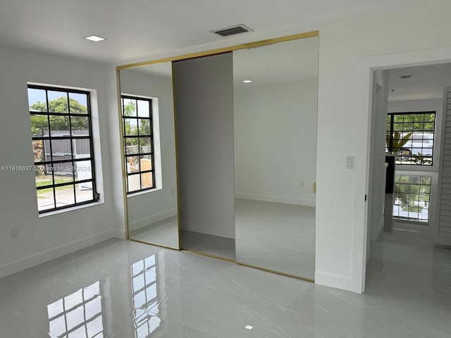 4314 SW 97th Ct, Miami, FL 33165 - unfurnished bedroom with multiple windows, baseboards, tile patterned floors, and a closet