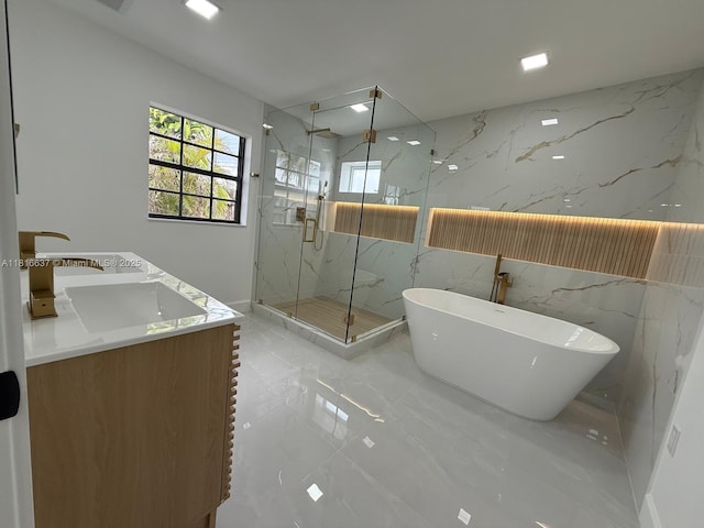 4314 SW 97th Ct, Miami, FL 33165 - bathroom featuring marble tiled flooring, a marble finish shower, a soaking tub, double vanity, and stone wall