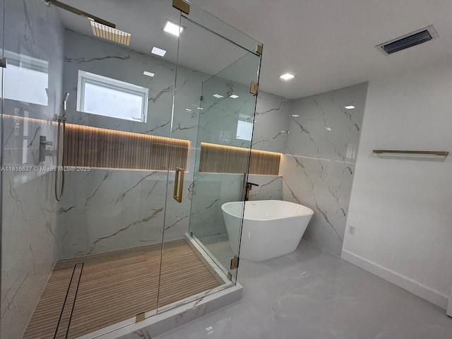 4314 SW 97th Ct, Miami, FL 33165 - bathroom with marble tiled floors, a marble finish shower, a freestanding bath, and stone wall