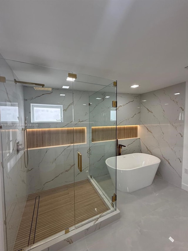 4314 SW 97th Ct, Miami, FL 33165 - bathroom with a marble finish shower, stone wall, a soaking tub, and marble tiled flooring