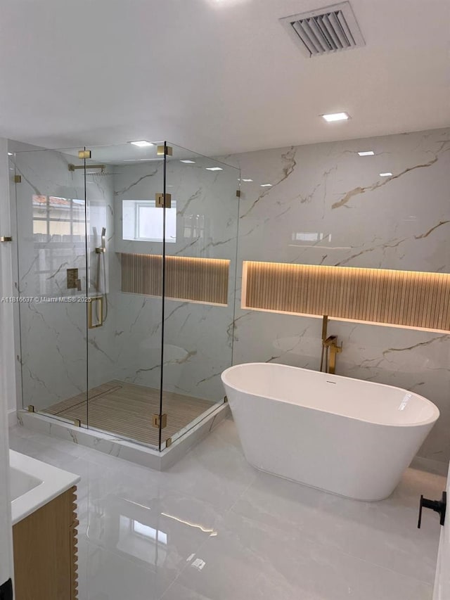 4314 SW 97th Ct, Miami, FL 33165 - full bathroom featuring stone wall, marble tiled floors, a freestanding bath, a marble finish shower, and vanity