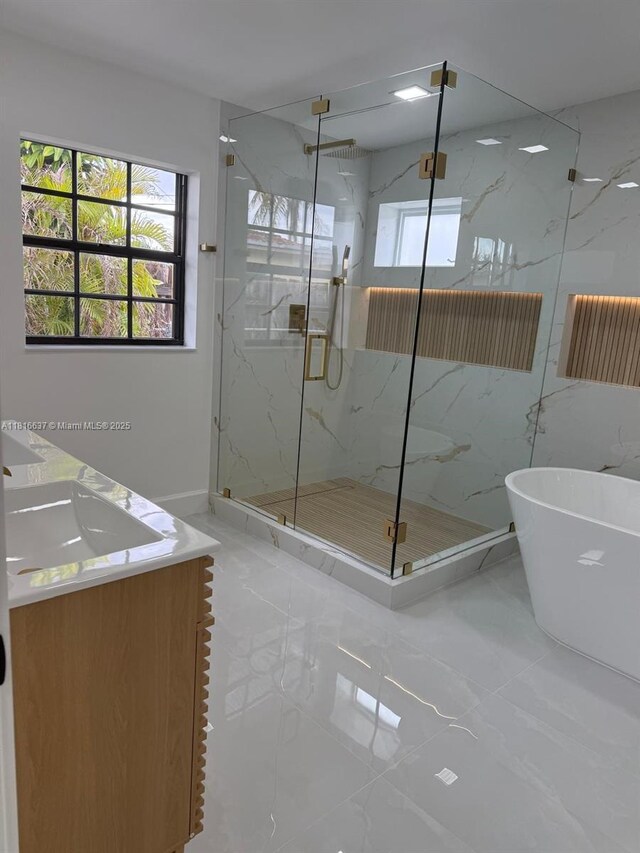 4314 SW 97th Ct, Miami, FL 33165 - bathroom with a marble finish shower, double vanity, a soaking tub, and marble finish flooring
