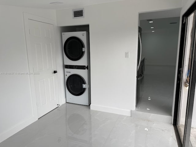 4314 SW 97th Ct, Miami, FL 33165 - laundry area featuring stacked washing machine and dryer and baseboards