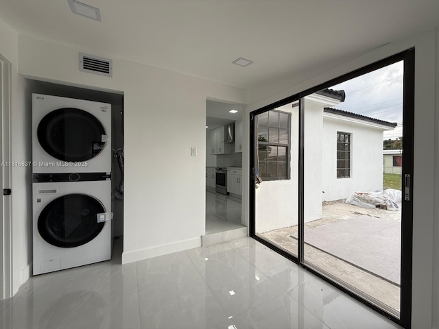 4314 SW 97th Ct, Miami, FL 33165 - laundry area featuring stacked washer / dryer, baseboards, and light marble finish flooring