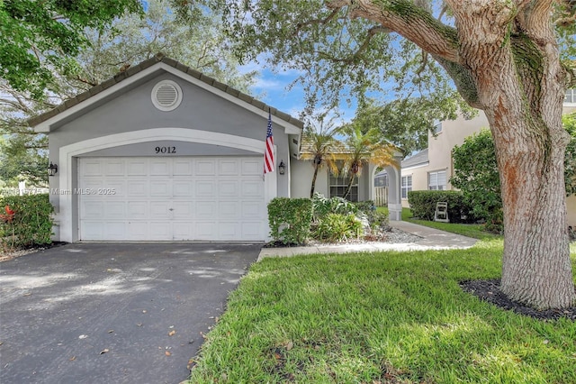 9012 Lake Park Cir S, Davie, FL 33328 - single story home featuring stucco siding, asphalt driveway, and an attached garage