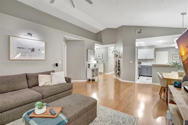 9012 Lake Park Cir S, Davie, FL 33328 - living area with light wood finished floors, vaulted ceiling, ceiling fan, and baseboards
