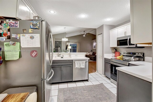 9012 Lake Park Cir S, Davie, FL 33328 - kitchen featuring appliances with stainless steel finishes, a sink, a textured ceiling, ceiling fan, and light countertops