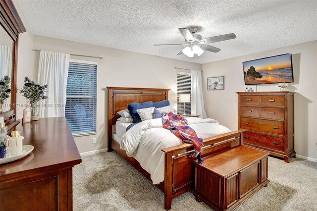 9012 Lake Park Cir S, Davie, FL 33328 - bedroom with light carpet, a textured ceiling, baseboards, and ceiling fan