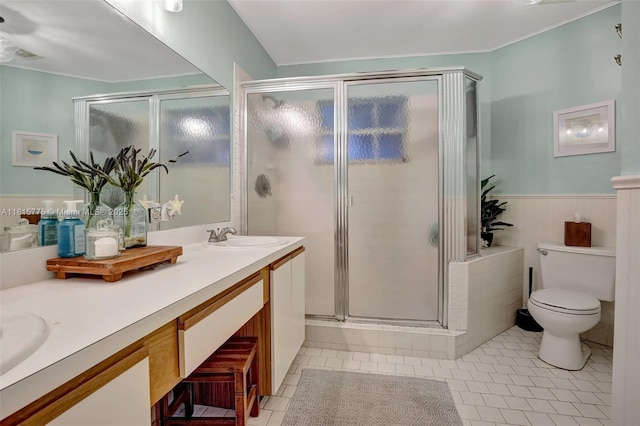 9012 Lake Park Cir S, Davie, FL 33328 - full bathroom featuring double vanity, a shower stall, tile patterned floors, toilet, and a wainscoted wall