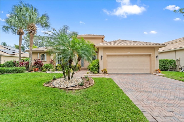 7215 Great Falls Cir, Boynton Beach, FL 33437 - mediterranean / spanish-style house featuring decorative driveway, stucco siding, and an attached garage