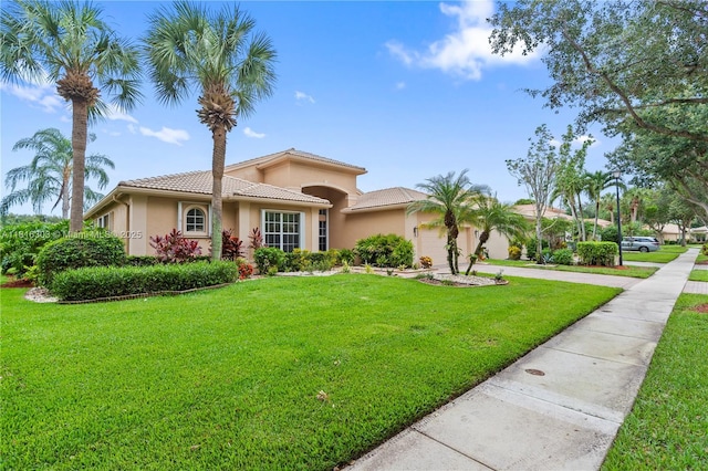 7215 Great Falls Cir, Boynton Beach, FL 33437 - mediterranean / spanish-style house with an attached garage, driveway, a front yard, stucco siding, and a tiled roof