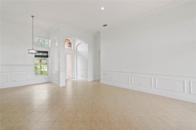 7215 Great Falls Cir, Boynton Beach, FL 33437 - unfurnished room featuring crown molding, a decorative wall, light tile patterned floors, arched walkways, and recessed lighting