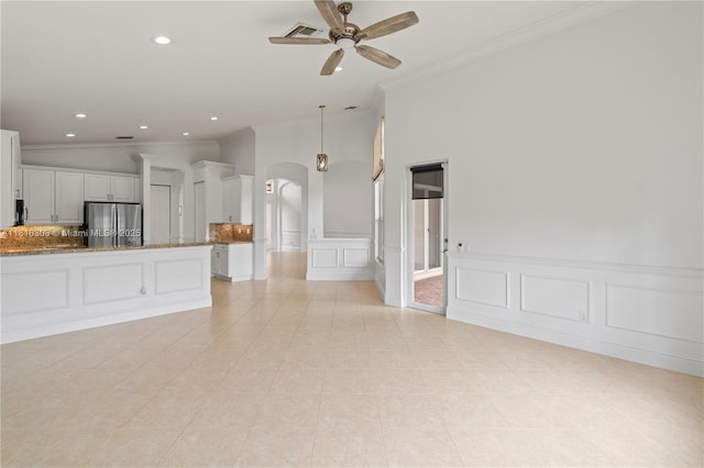 7215 Great Falls Cir, Boynton Beach, FL 33437 - unfurnished living room featuring arched walkways, crown molding, a ceiling fan, recessed lighting, and light tile patterned floors