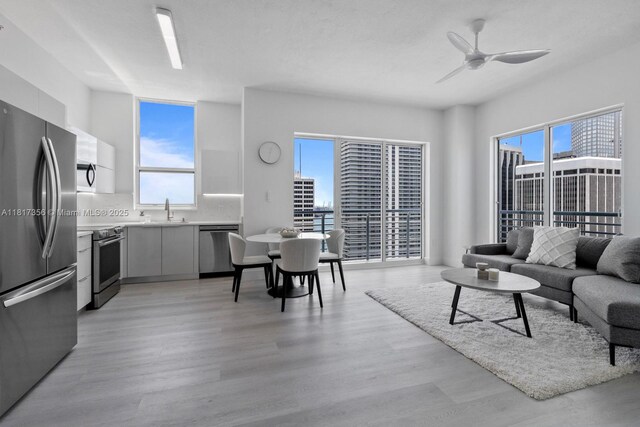 133 NE 2nd Ave Unit 2712, Miami, FL 33132 - living area with light wood finished floors, ceiling fan, and plenty of natural light