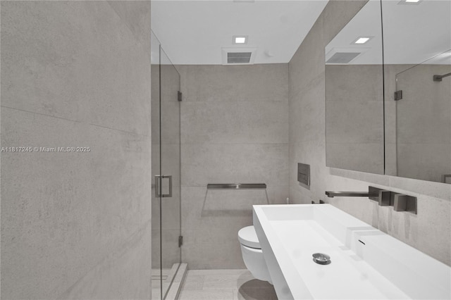 5700 Collins Ave Unit 7A, Miami Beach, FL 33140 - bathroom featuring toilet, a shower stall, tile walls, and vanity